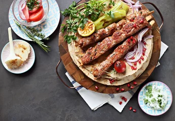   Kebab. Traditional middle eastern, arabic or mediterranean  meat kebab with vegetables and herbs. Overhead view, copy space © losangela