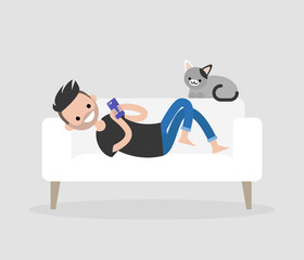 Fototapeta premium Millennial character lying on a sofa and checking the smartphone. Social networks and apps. Flat editable vector illustration, clip art. Modern lifestyle. Communication technologies.