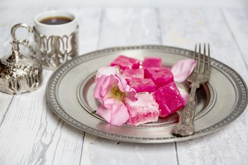 traditional bulgarian rose lokum on a silver plate and turkish coffee