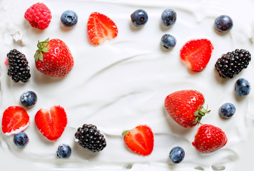 Mixed berries of strawberries, blackberries, blueberries, raspberries in milk cream. Healthy food. Copy space