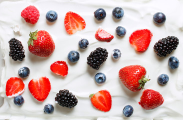 Mixed berries of strawberries, blackberries, blueberries, raspberries in milk cream. Healthy food. Copy space