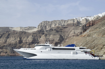 Fototapeta na wymiar New white catamaran passenger ferry in port Santorini