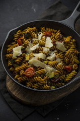 Whole wheat pasta with vegetables on cast iron pan