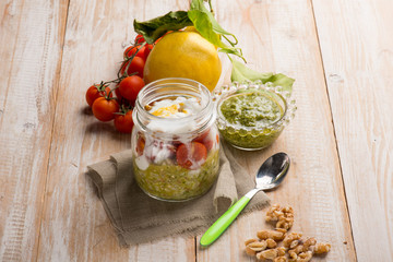 spelt with pesto tomatotes yogurt sauce and grated lemon peel