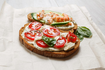 healthy open sandwich with tomatoes, shrimps and ricotta cheese