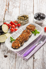 baked eggplant filled with caper tomatoes and black olives