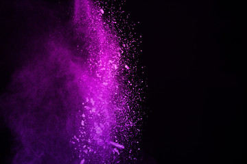 Colorful powder explosion on black background. Colored cloud. Multicolor dust explode. Paint Holi.
