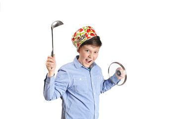 Fototapeta premium Boy with a pot on a head holding steel soup ladle and pot lid isolated on white background
