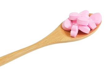 Wooden Spoon Full with Vitamins C on White Background