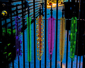 Mardi Gras beads on wrought iron gate