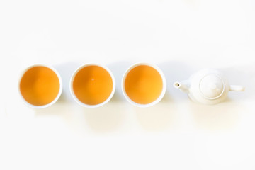 Green tea and cup of green tea on white. Top view and concept. Teatime. Copy space.