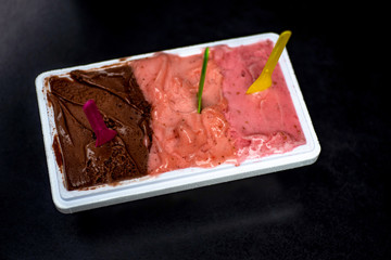 Raw Ice-cream Gelato and Sorbet combo in open container: three type of dessert (different colors)- chocolate, strawberry and raspberry.
