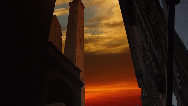 Two Towers of Bologna - Asinelli and Garisenda towers, Bologna, Italy, at sunset, time lapse