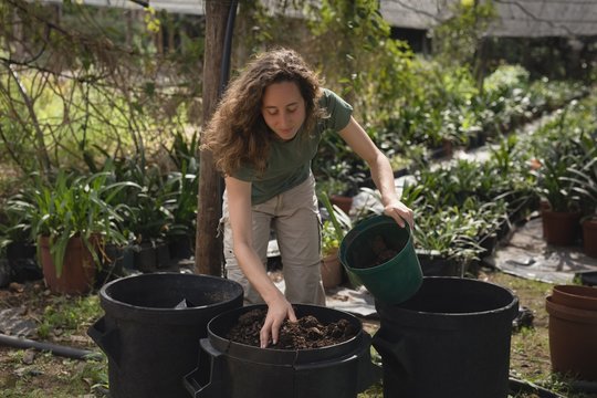 Farmer preparing soil into bucket