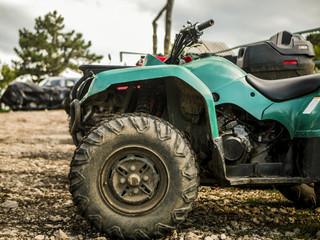atv in a mountain parking zone on a rainy summer day