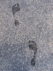 A wet footprint outside on the concrete 