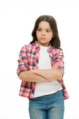 Obraz premium Offended feelings. Child offended keep silence. Girl serious face offended white background. Kid unhappy looks strictly. Girl folded arms on chest looks serious. Sensitive girl not want to talk