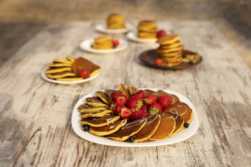 Pancakes with fruit. Breakfast with punkcakes. Pancakes in a pile on a plate.