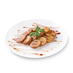 Healthy food: grilled sweet potatoes with basil served with sour tomato sauce close up on a white background.