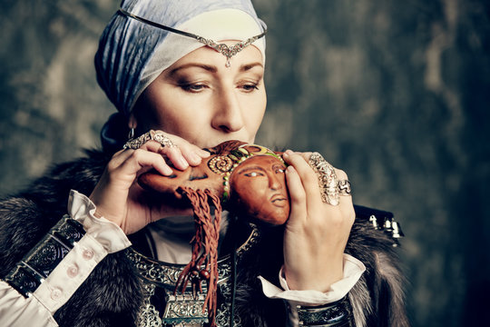 woman plays the reedpipe