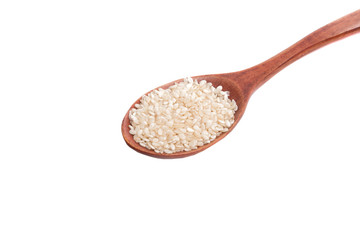 white sesame seeds in wooden spoon isolated on the white
