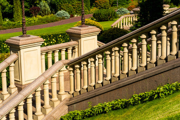 railing made of stone among the greenery near the house