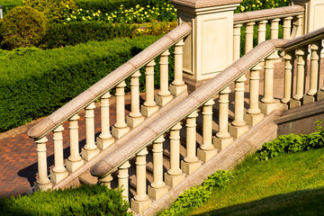 Stone steps with balusters and marble rails among the green landscape