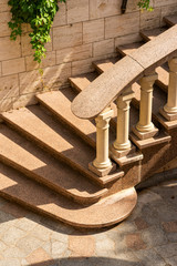 marble railings and steps with balusters and a green bush of grapes