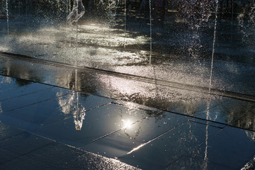 The sprays and puddles of the fountain