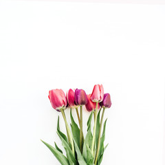 Woman hand holding tulips bouquet on white. Flat lay, top view flowers festive background.