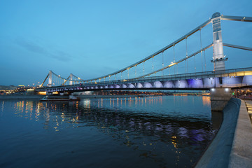 Naklejka na ściany i meble Brightly illuminated bridge at the sunset in Moscow