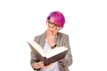 Pensive woman reading book in glasses