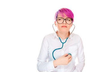 Confused woman listening herself with stethoscope