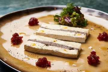 Brie cheese with truffle and jelly barberry. Delicious dish with red wine, champignons mushrooms and truffle oil at the restaurant table, top view. Vegetarian delicacy diet food