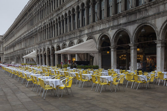 In the early monring empty yellow chairs adorn San Marco plaza,  Venice Italy.