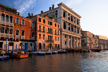 Boats, gondolas and colorful architecture viewed from boat in the Grand canal Italy
