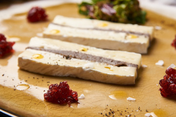Brie cheese with truffle and jelly barberry. Delicious dish with red wine, champignons mushrooms and truffle oil at the restaurant table, top view. Vegetarian delicacy diet food