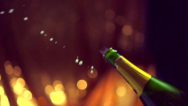 Champagne explosion. Sparkling wine popping, opening champagne bottle closeup. Slow motion. 4K UHD video footage. 3840X2160