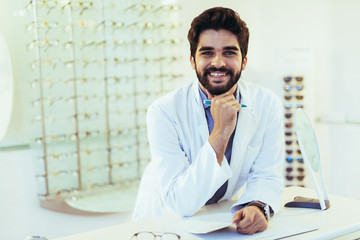 Man optician in coat at optics store