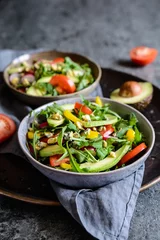 Foto op Plexiglas Healthy arugula salad with avocado, radish, bell pepper, tomato and Roquefort cheese © noirchocolate