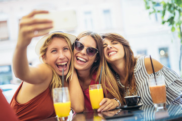 Three young women in a cafe after a shopping