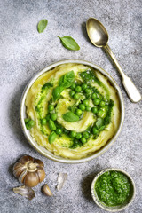 Mashed potato with pesto sauce and sweet pea.Top view.
