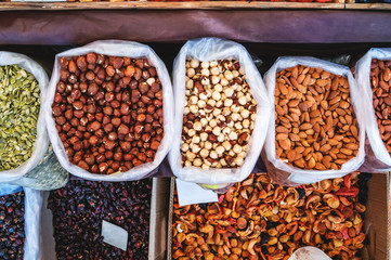 Fresh peeled walnuts, hazelnuts and raisins in the street market. Nut kernel. The concept of organic food