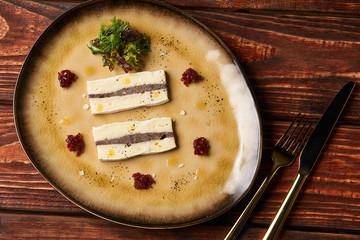 Slice of Fresh Brie cheese with truffle and jelly barberry. Delicious dish with red wine, champignons mushrooms and truffle oil at the restaurant table. Vegetarian delicacy diet food