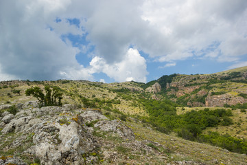 Fototapeta na wymiar Green Mountains and Blue Cloudy Sky Nature Landscape Background