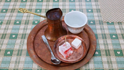 Traditional turkish coffee pot and delight rahat lokum on vintage plate