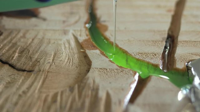 The woodworker pours the table top with epoxy resin. 4k