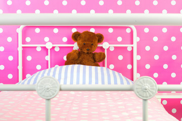 Pink bedroom with toy bear