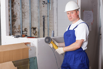 Contractor using angle grinder