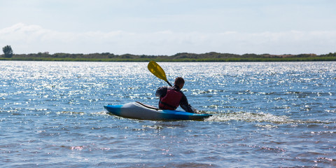 a man is floating on a kayak on the lake